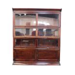 A Globe Wernicke style three section bookcase, with cupboards below, raised on a plinth base,