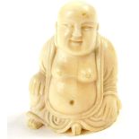 An Oriental ivory figure of a seated Buddha, (being part of another composition with insert to