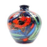 An Anita Harris art pottery vase decorated in the Thal pattern, painted with carp against a blue