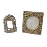 An Edwardian silver strut photograph frame, silk backed, embossed with cherubs and rococo scrolls,
