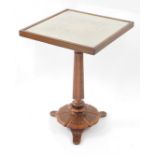 A Victorian occasional table, with lace work and glazed tilt top, on a column and shaped base with