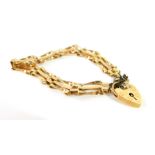 A 9ct gold three bar gate bracelet, on a heart shaped padlock clasp, with safety chain as fitted,