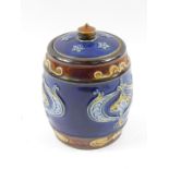 A Royal Doulton stoneware tobacco jar, decorated with Art Nouveau floral motifs against a blue