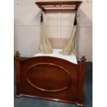 A Victorian mahogany half tester bed, with moulded overhanging cornice, and footboard with turned