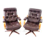 A pair of modern cantilever swivel office chairs, with brown leather effect upholstery and faux