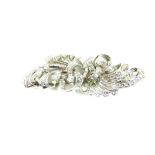 A diamond set spray brooch, of tied scrolling form, set with brilliant and baguette cut diamonds, in