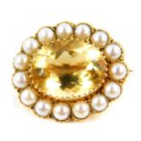 A 9ct gold and oval cut citrine brooch, in a surround of pearls, citrine approx 10.5cts, 8.3g.