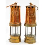 A pair of Patterson Lamps Ltd copper and brass miner's safety lamps, Nos 156 and 357.