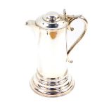 A 17thC style silver plated quart flagon, with a hinged lid and S scroll handle raised on a