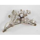 A diamond set floral spray brooch, baguette and brilliant cut diamonds, set in white metal,
