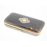 An early 20thC tortoiseshell bound spectacles case, with silver pique decoration, 14cm wide.