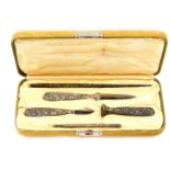 A silver handled five piece desk set, comprising pen and pencil, seal, paper knife and cutter,