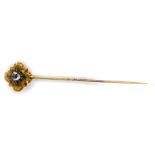 A Victorian stick pin set with an old cut diamond, in white and yellow metal, approx 0.4cts.