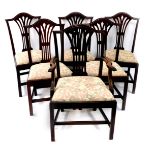 A set of six George III mahogany dining chairs, including carver, with Hepplewhite style pierced