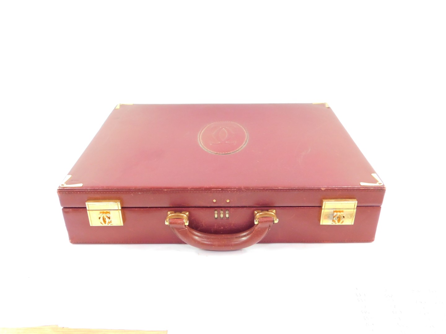 A Le Must De Cartier red leather briefcase, with brass fittings and mounts, Rd 1975, 43cm wide.