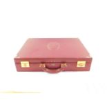 A Le Must De Cartier red leather briefcase, with brass fittings and mounts, Rd 1975, 43cm wide.
