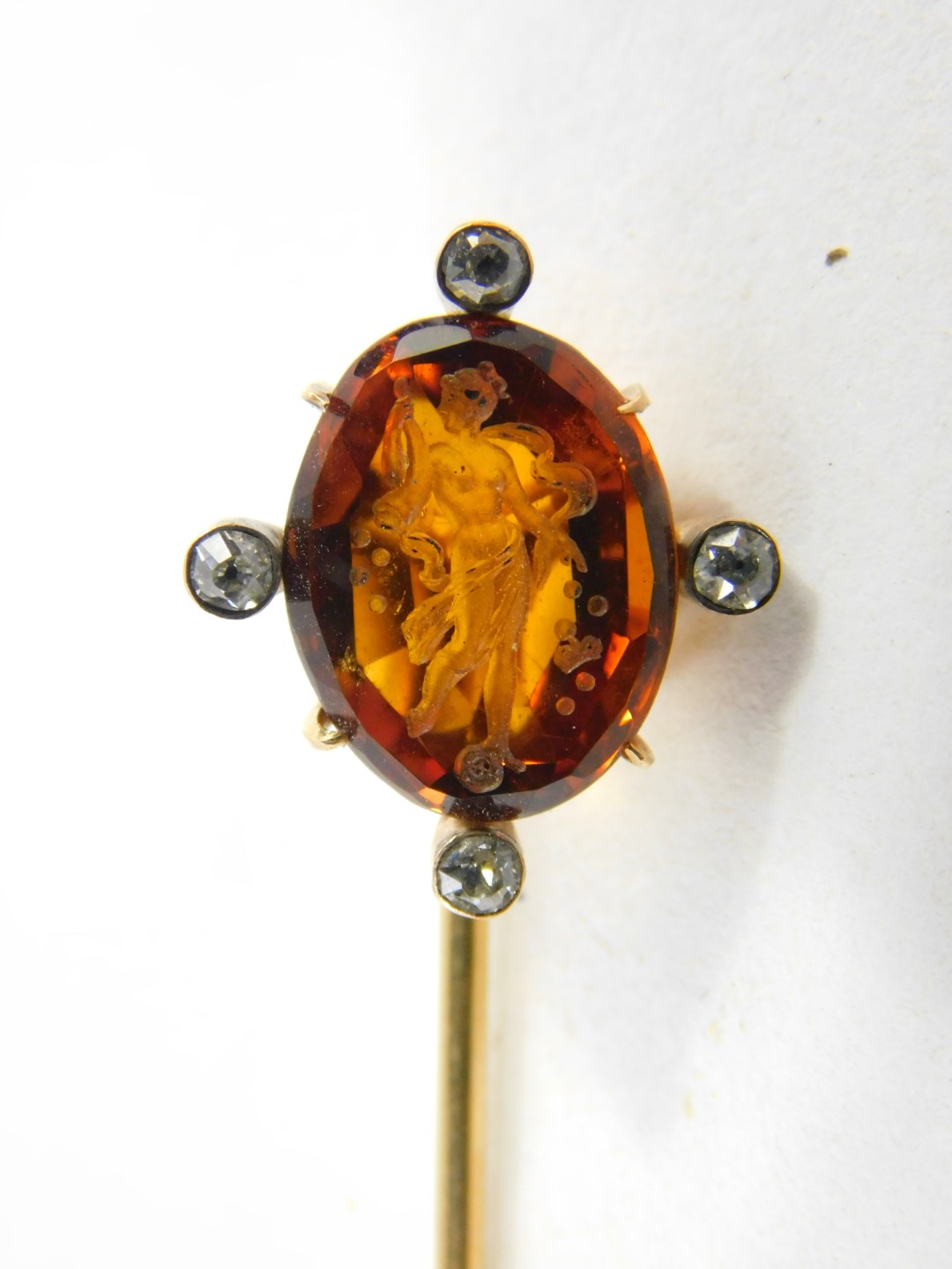 A Victorian topaz stick pin, intaglio carved with a classical goddess, set with four diamonds at - Image 2 of 2