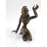 An early 20thC bronze figure of a Buddhist goddess, modelled semi naked and seated, 12cm high.