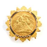 An Edward VII gold half sovereign 1902, in a 9ct gold brooch mount, 6.2g.