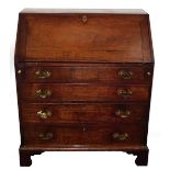 A George III mahogany bureau, with fall flap resting on loppers and revealing a fitted interior,