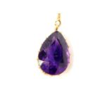 A pear shaped amethyst pendant, set in yellow metal, on an oval link neck chain, with bolt ring