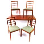 A 1970's teak extending dining table, with folding centre section, and four ladder back chairs