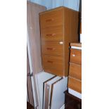 A flat pack oak effect three door wardrobe, together with a chest of four drawers, 85cm high, 38cm