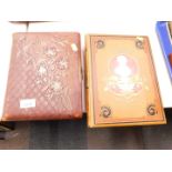 An embossed leather photograph album, together with The Complete Works of William Hogarth, with