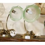 A pair of brass table lamps, with frilled etched glass and green edged shades.