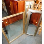 Three wall mirrors, comprising two gilt framed mirrors and a silver framed mirror, 123cm x 35cm,