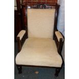 A Victorian armchair, upholstered in a fawn coloured chenille.