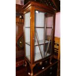 A mid 20thC oak china cabinet, raised on cabriole legs, 117cm high, 56cm wide, 31cm deep.