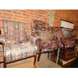 Three Parker Knoll armchairs, upholstered in a Kelim style fabric, with additional cushions. The