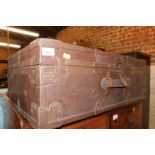 A wooden and metal bound trunk, with partial lettering remains to the top, 26cm high, 74cm wide,