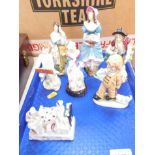 Continental porcelain and pottery figures, chiefly late 19thC, together with a fairing 'Three O'