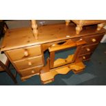 A waxed pine dressing table, with six drawers and swing frame mirror, 156cm high, 147cm wide, 46cm