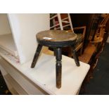 A beech and elm milking stool, 23cm high.