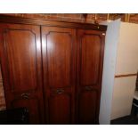 A white two door wardrobe, mahogany effect wardrobe, and a fire guard. (3)