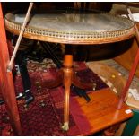 A reproduction mahogany occasional table, with a green leather insert and brass galleried top,