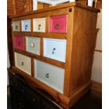 A pine chest of multi-coloured graduated drawers, four over three over two drawers, 83cm high, 101cm