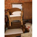 A wicker four piece conservatory suite, comprising sofa, two chairs, and a coffee table.