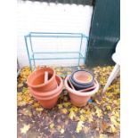 A green three tier plant pot stand, together with assorted plant pots. (a quantity)