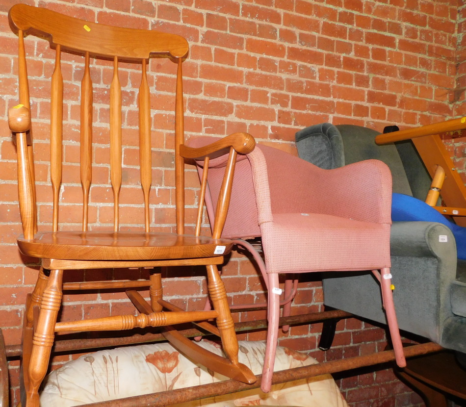 A beech rocking chair, together with a pink tub chair. (2)