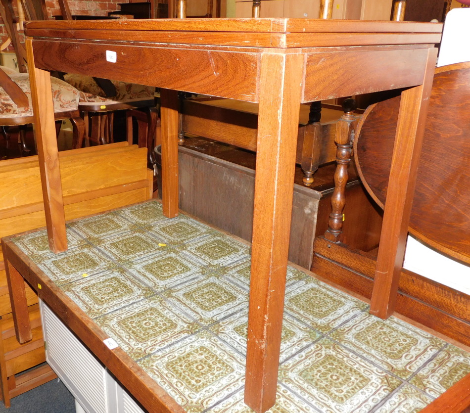 A teak games table, stamped verso AC (Military mark) 1975, raised on square legs, 71cm high, 92cm