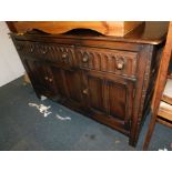 An Ercol style dark stained sideboard, with three drawers over three cupboards doors, 90cm high,