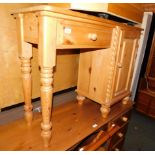 A waxed pine dressing table, with single drawer and side cupboard, 78cm high, 103cm wide, 37cm