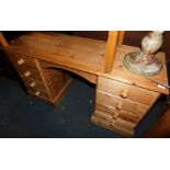A waxed pine desk or dressing table of eight drawers, 77cm high, 130cm wide, 43cm deep.