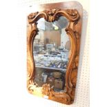 A Victorian walnut framed wall mirror, with leaf and rococo scroll carving, 69cm high, 40cm wide.