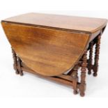 An early 20thC oak gate leg table, on bobbin turned legs with orb feet and D end top, (when closed)