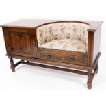 An Old Charm style oak finish linen fold telephone seat, with overstuffed embroidered seat, panelled